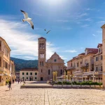 Main square in old medieval town Hvar with seagull's flying over. Hvar is one of most popular tourist destinations in Croatia in summer. Central Pjaca square of Hvar town, Dalmatia, Croatia.