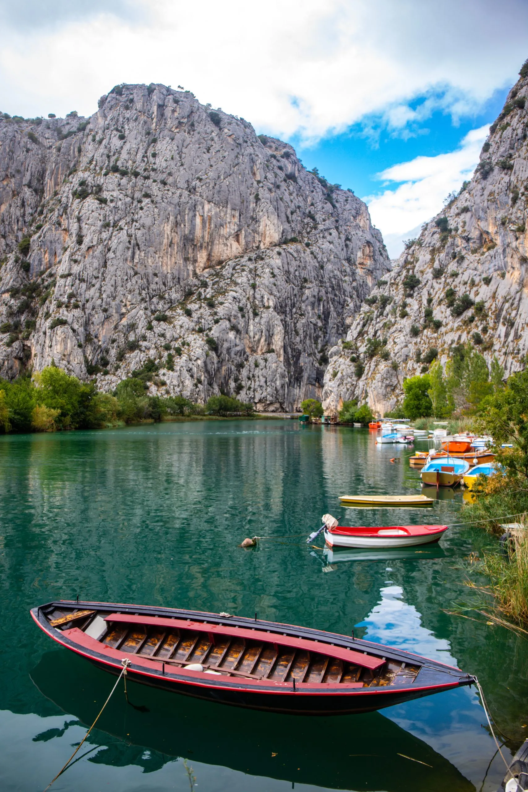 panorama of the town of omis in croatia on the adriatic coast; the famous old town at the mouth of the cetina river; old buildings surrounded by huge mountains in a canyon